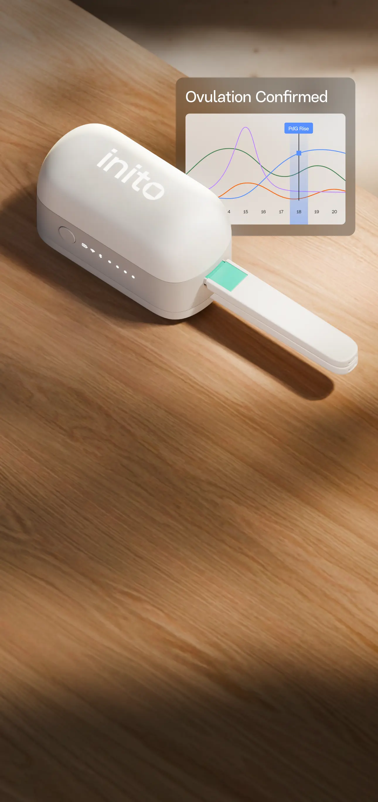 Inito fertility monitor device on a wooden desk
