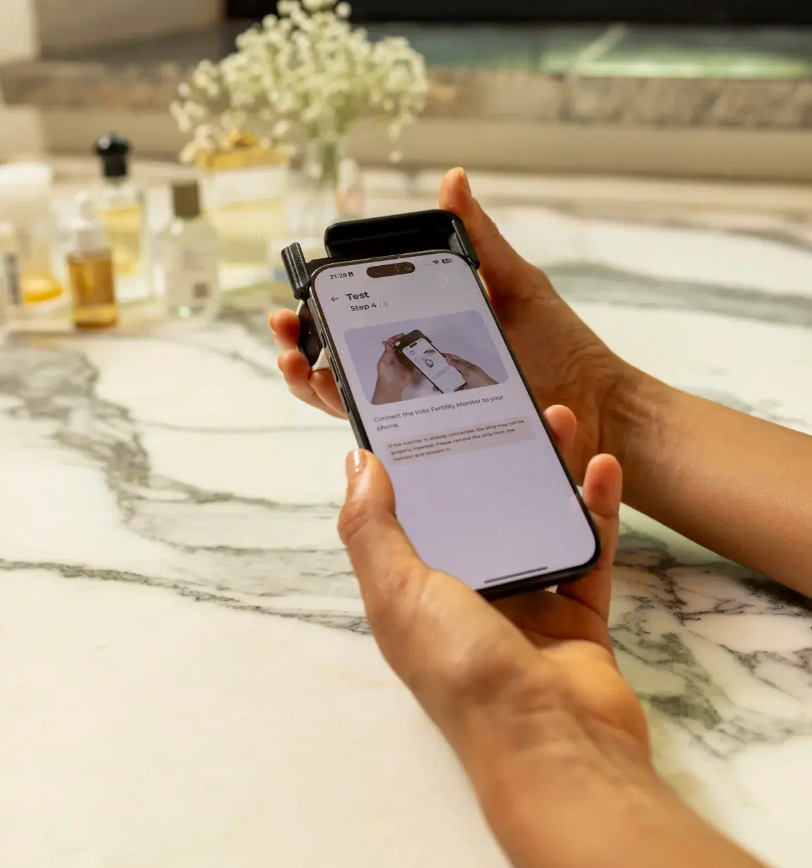  Attach the Inito Fertility tracker to your iPhone*.